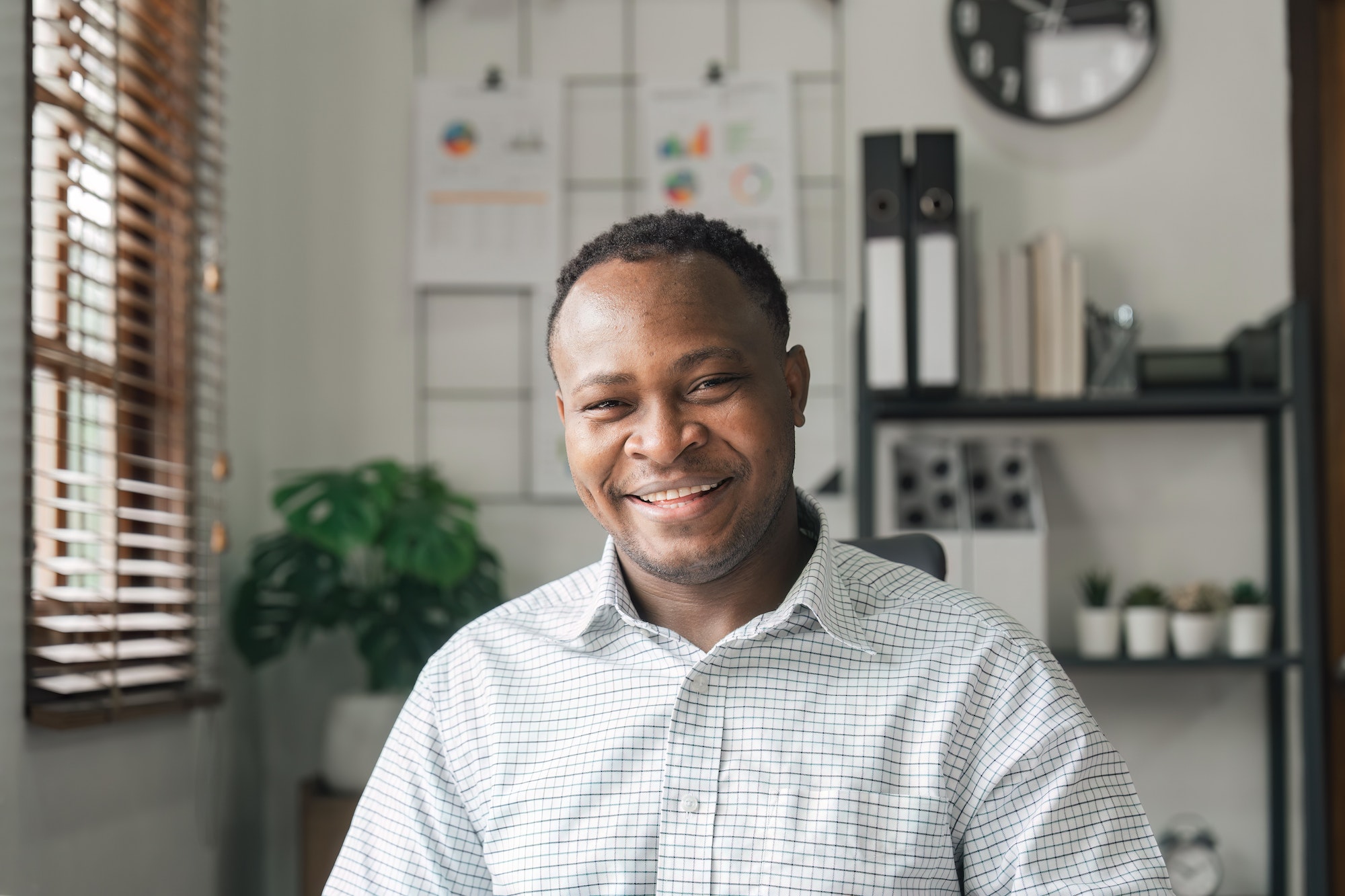 Portrait of happy African American small business owner looking at camera. Head shot
